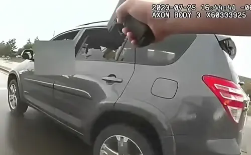 Officer pointing gun at Alysha Duran